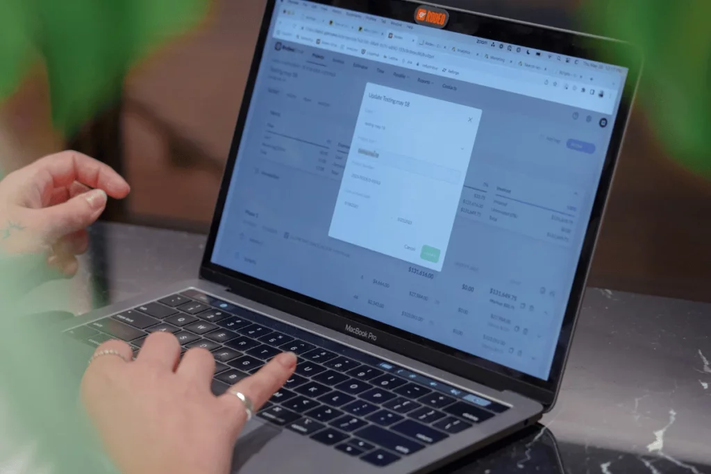 Person updating financial records on MacBook Pro.